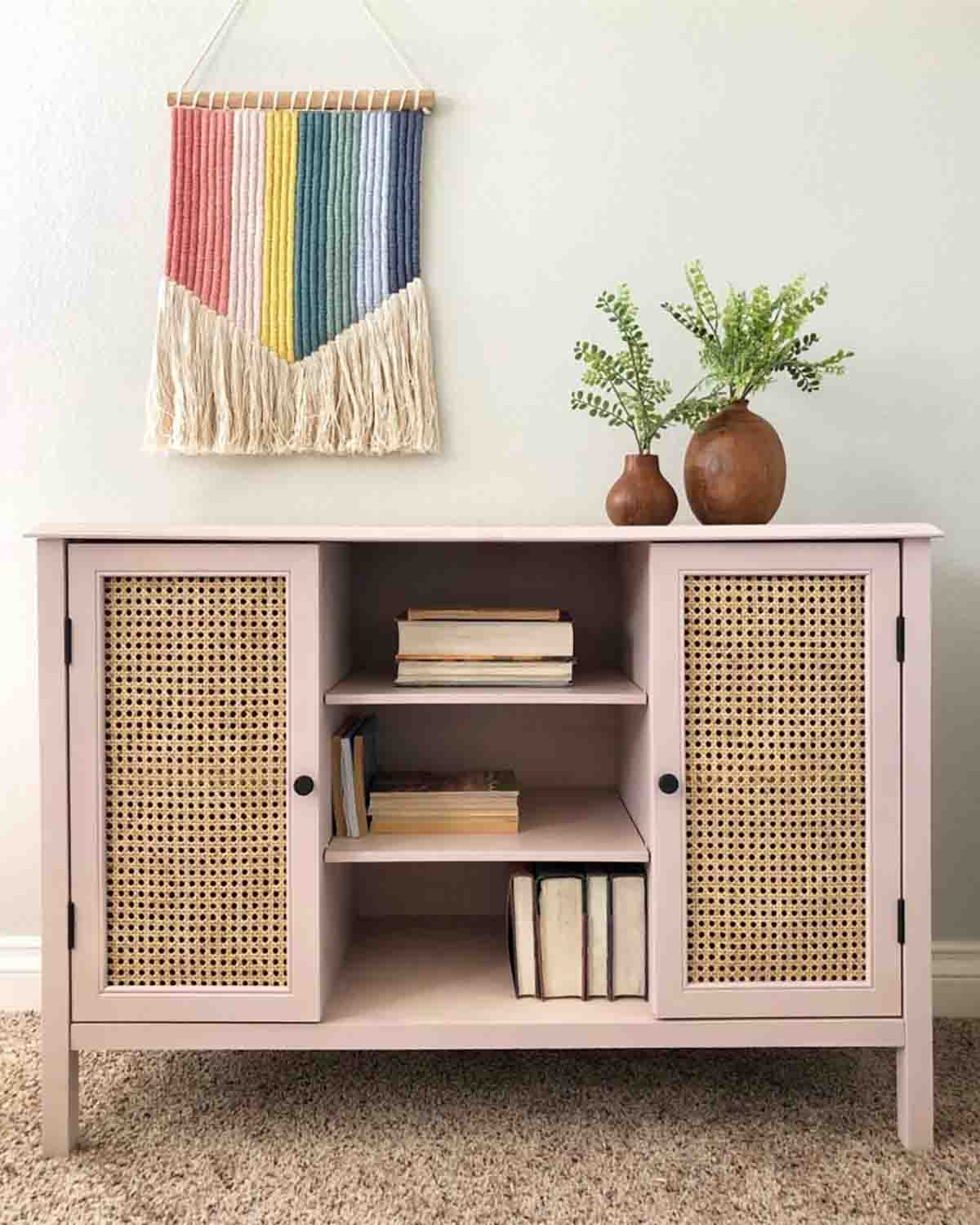pink painted console with cane webbing doors.