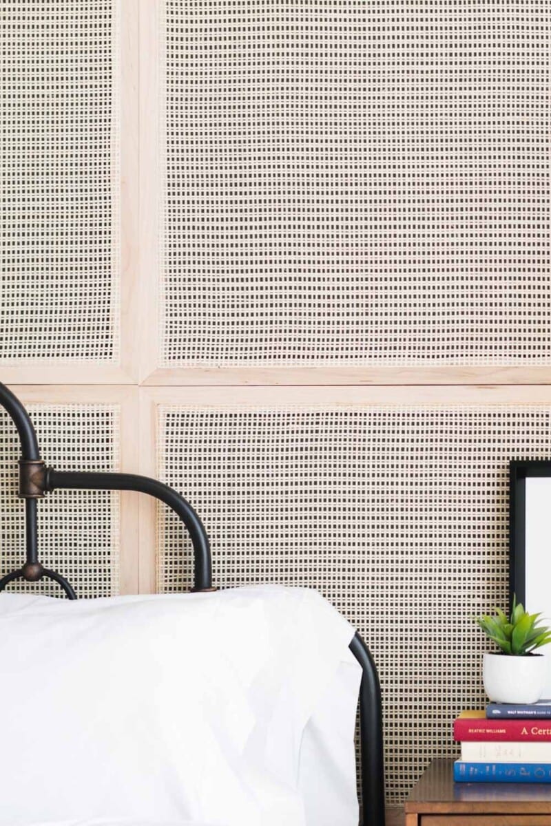 Cane webbing wall panels behind bed