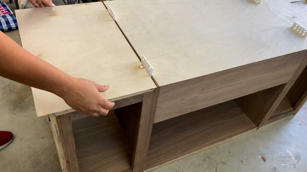 Woman attaching plywood to the record player cabinet