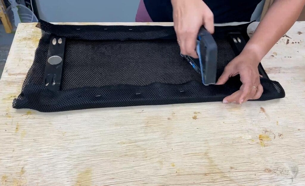 Woman making the speaker covers by upholstering the frame