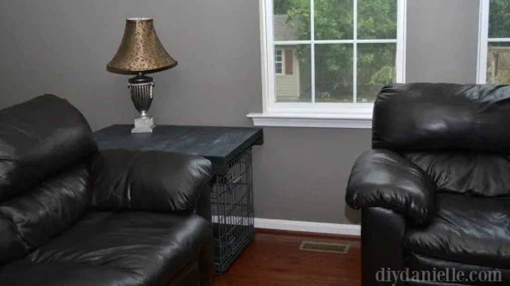 dog crate next to couch with wooden topper turning it into a side table