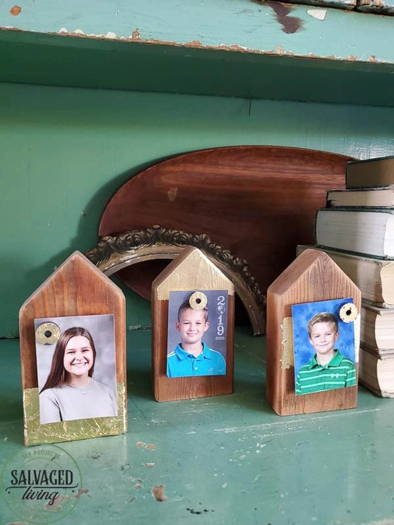 Three picture holder shaped like houses made from 2x4 scrap wood