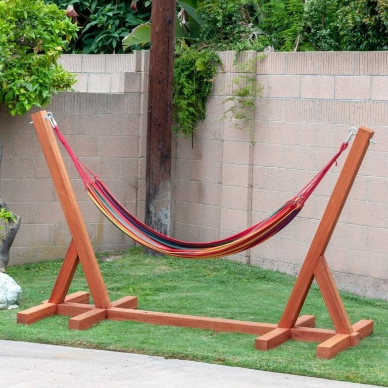 completed DIY hammock stand sitting in grassy corner of yard