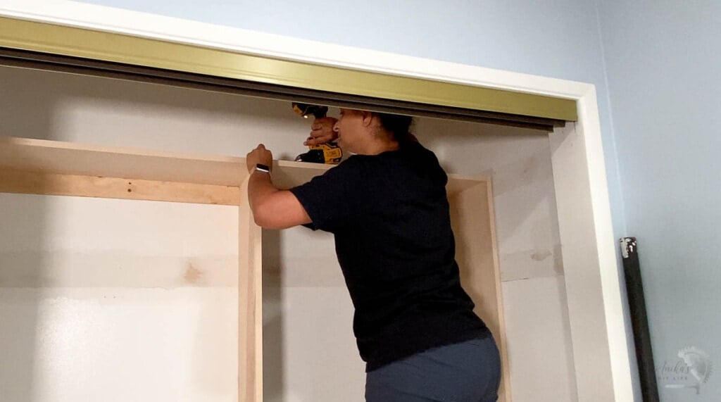 attaching the closet organizers together in the closet