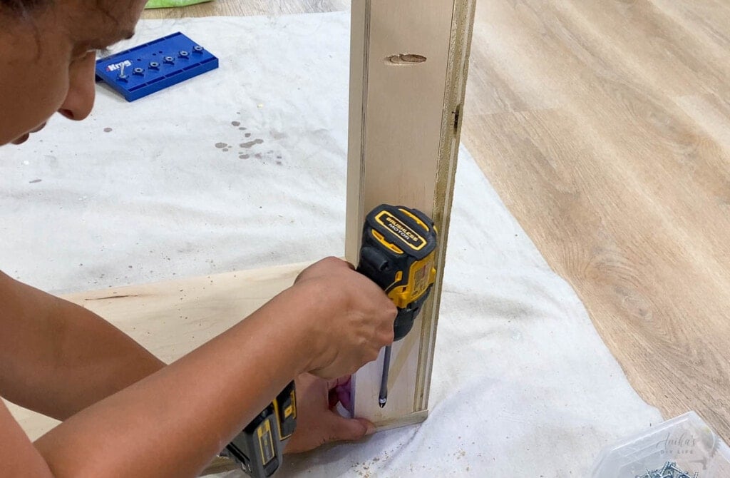 Woman attaching the cleat for a custom closet organizer