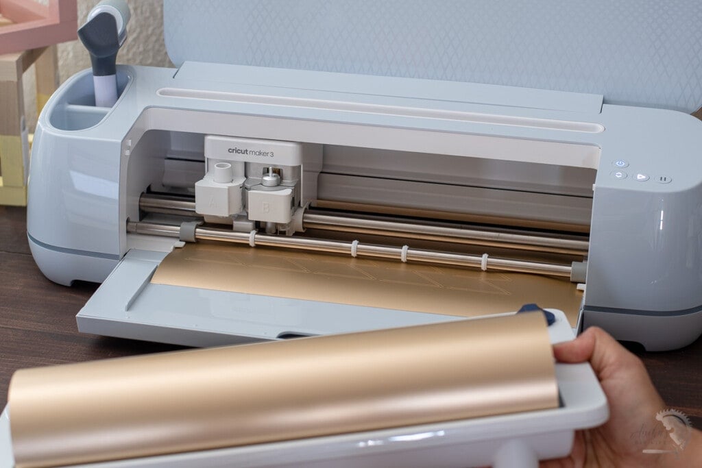 Woman removing the roll holder from the Cricut Maker 3
