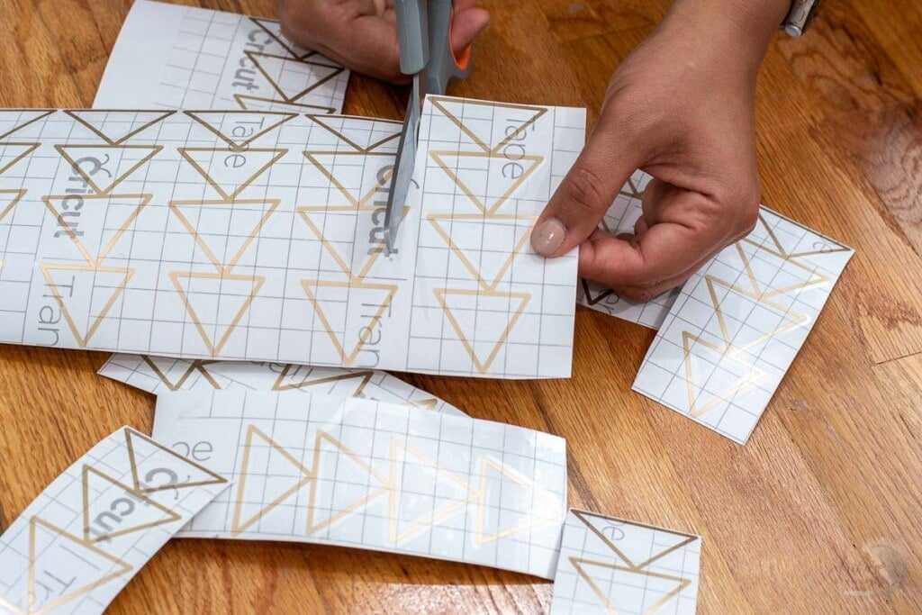 cutting out all the designs to apply to the wall