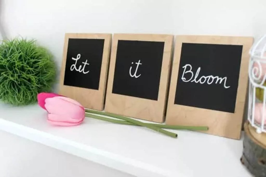 three scrap plwood signs with chalkboard paint and words written on them