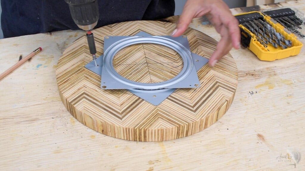 attaching the lazy susan top to the hardware with screws