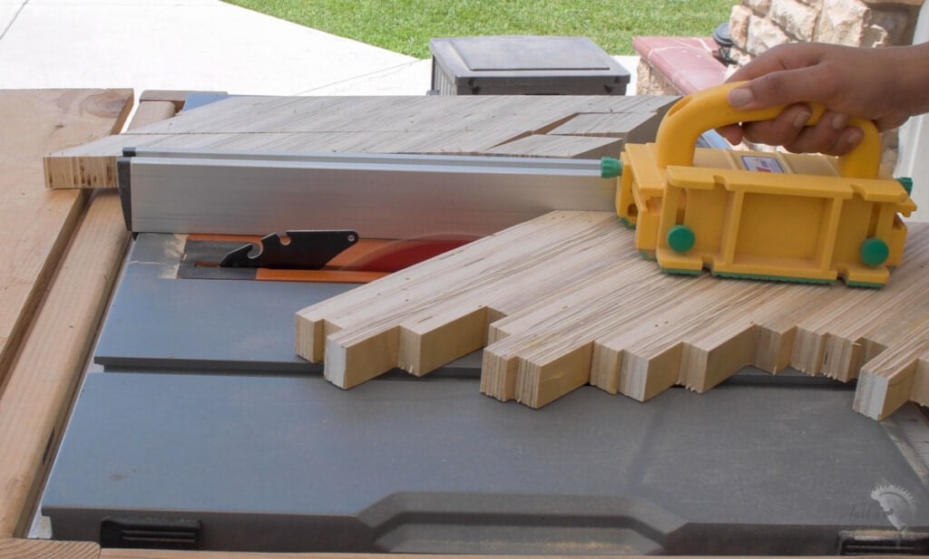 Cutting out strips of the patterned plywood to make the chevron patterned plywood
