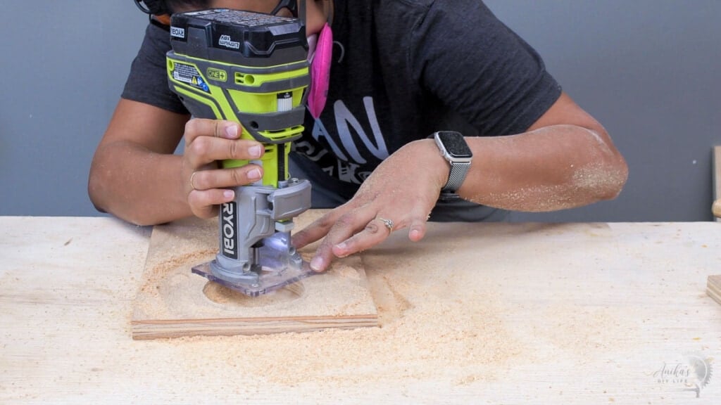 woman routing plywood to accomodate the wireless charger