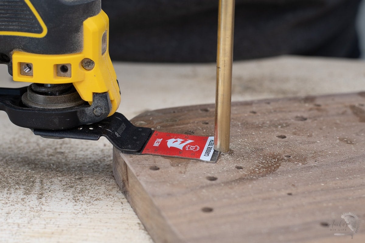 Cutting off the brass rod with an oscillating tool,