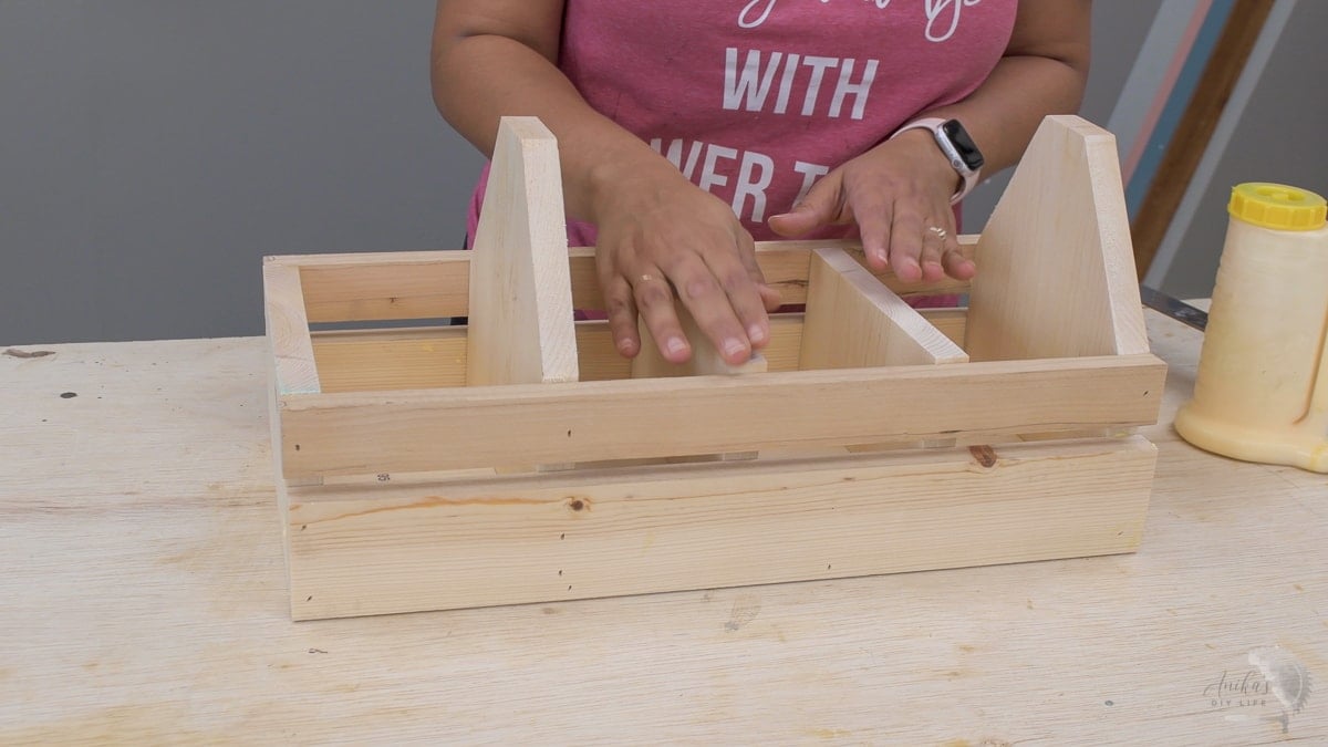woman adding dividers in. the tool box