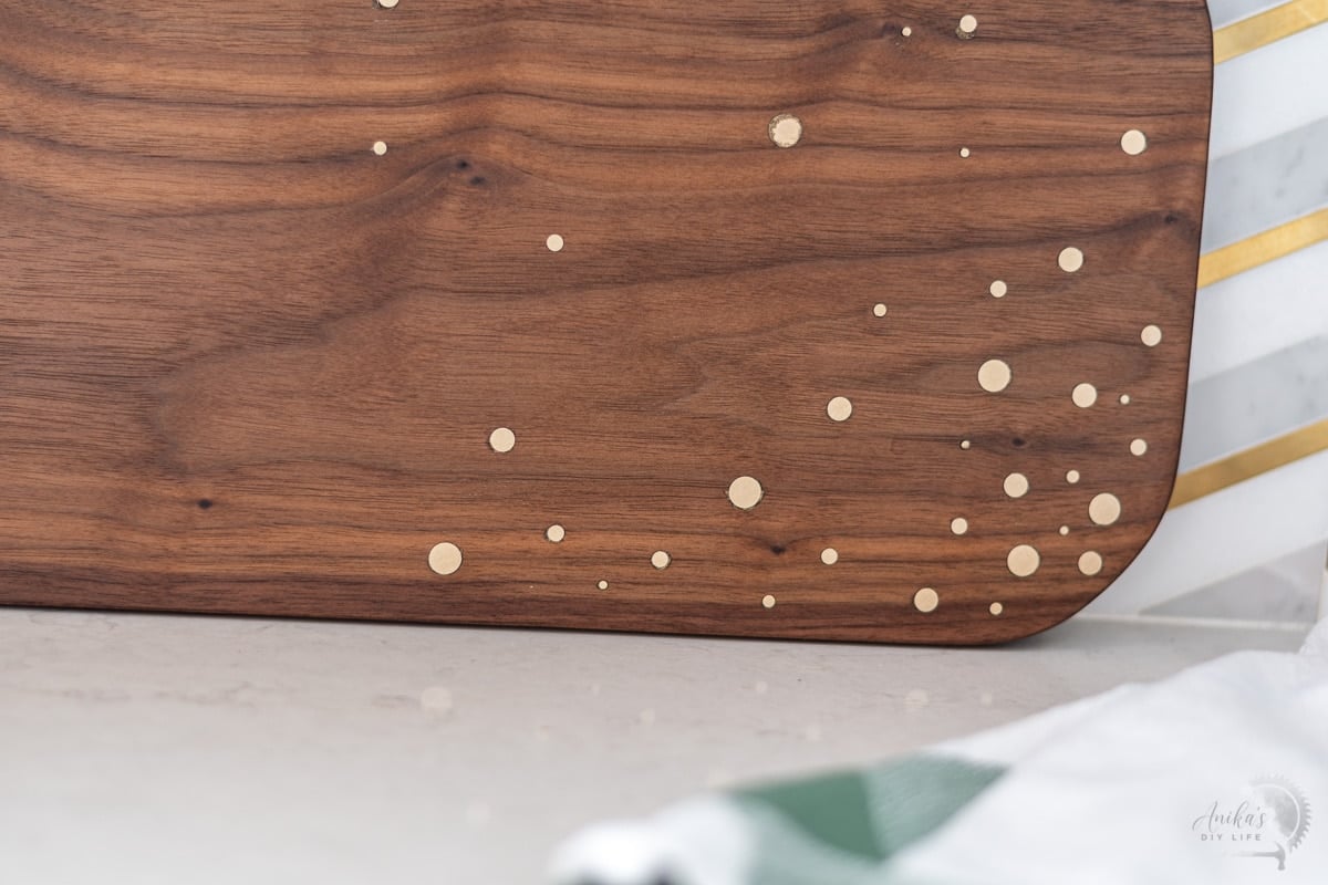 close up of the walnut cutting board with brass inlay