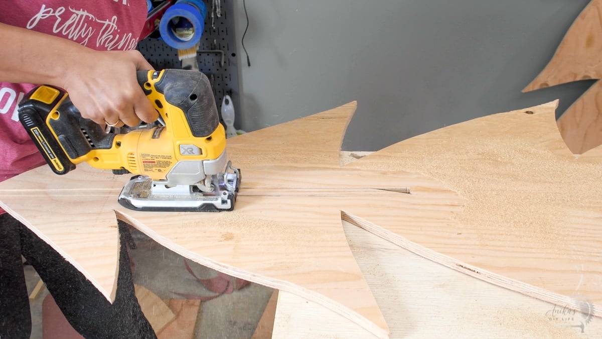 Woman cutting slot with a jigsaw