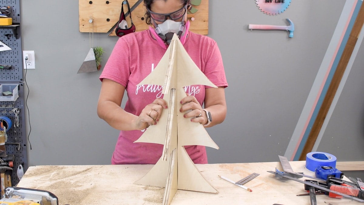 Woman making a plywood Christmas tree