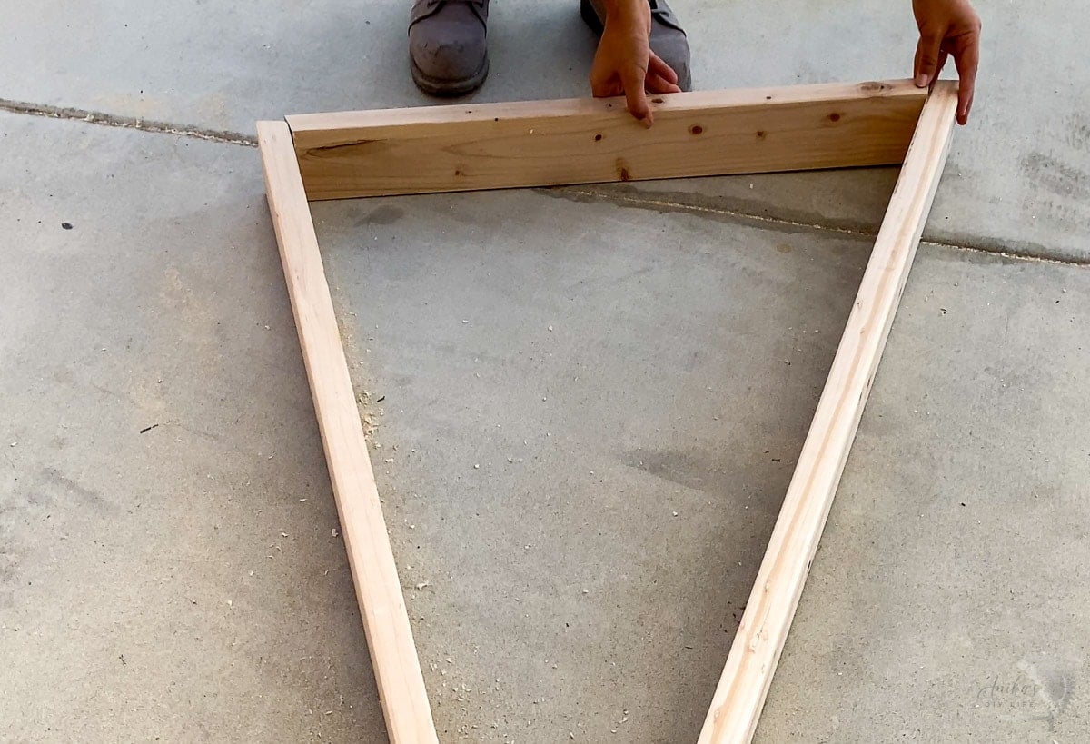 Woman putting together the bottom of the Christmas tree shelf