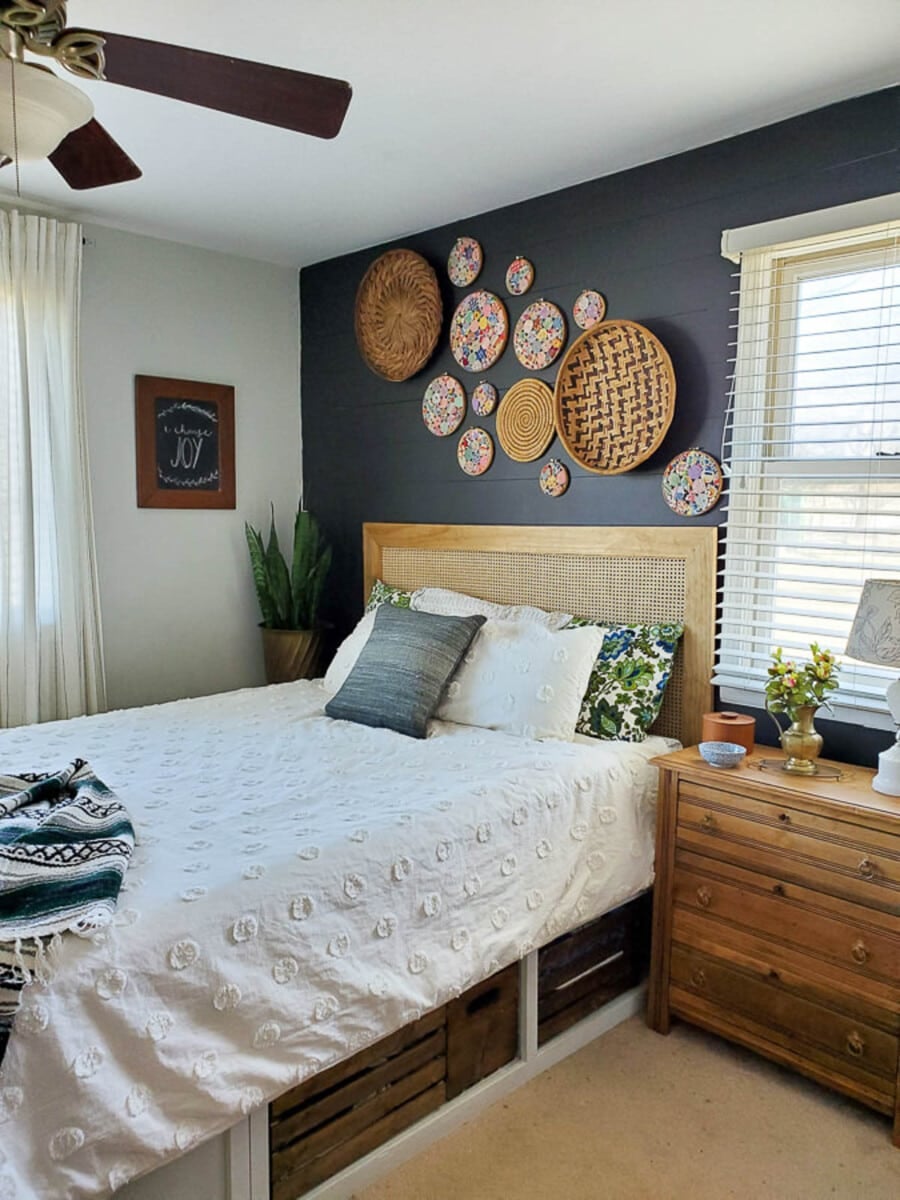 DIY cane headboard against a black wall