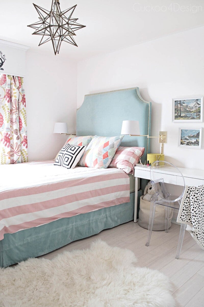 blue fabric headboard with nailhead trim