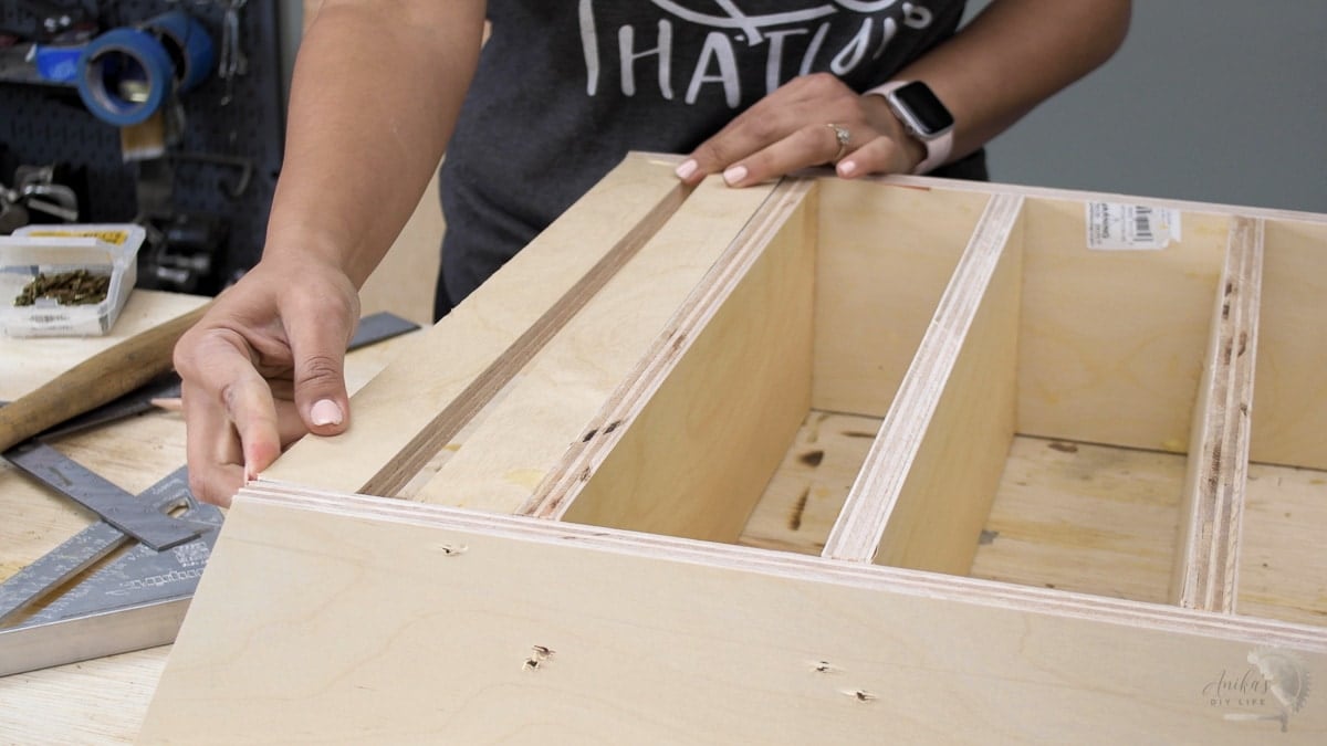 woman attaching supports on a sand paper organizer