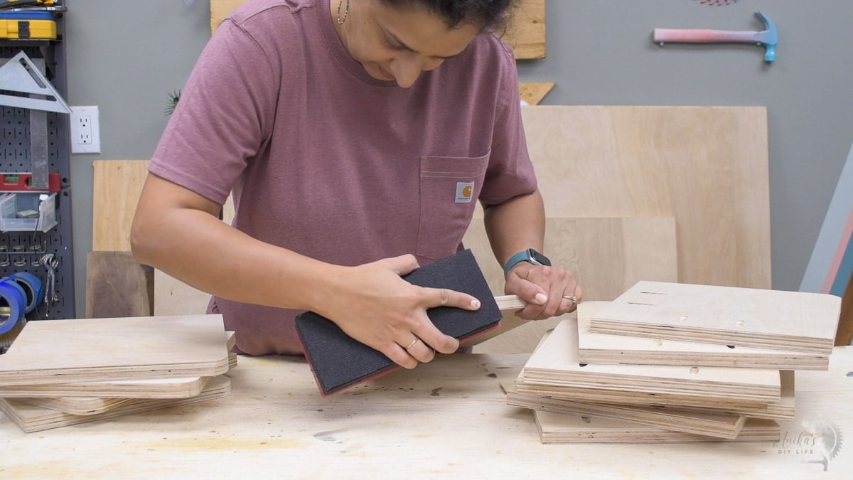 Woman sanding edges of plywood