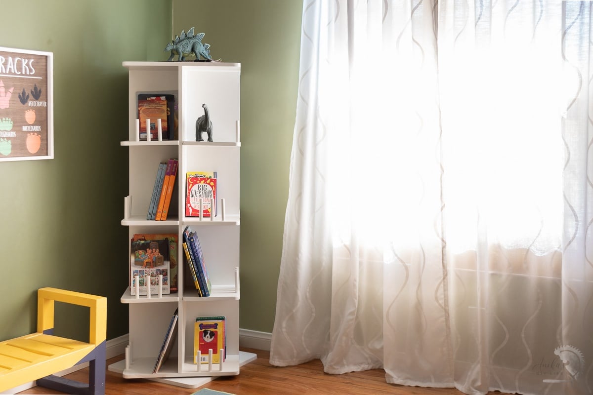 White rotating bookshelf in boys room