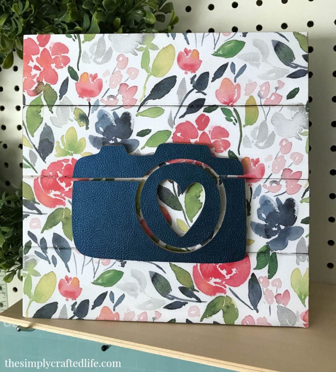 wood sign with flowered background and wooden camera