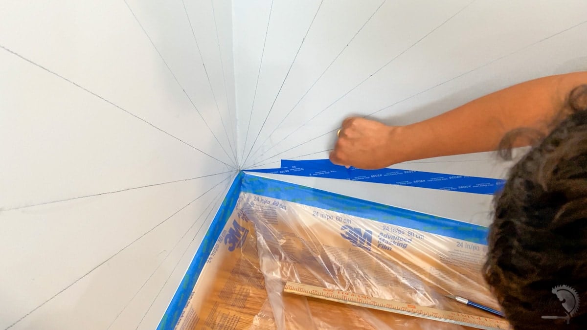 Woman cutting painters tape in corner