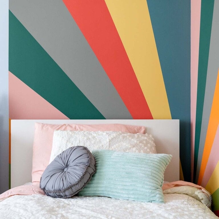 Learn how to paint a DIY Sunburst rainbow accent wall with this step-by-step tutorial. We added a little surprise by painting it in a corner!