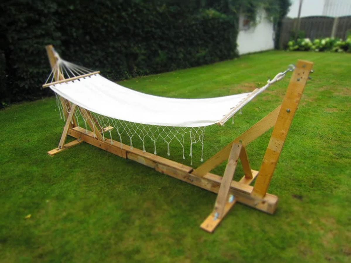 Hammock stand made with pallet boards in lawn with white hammock