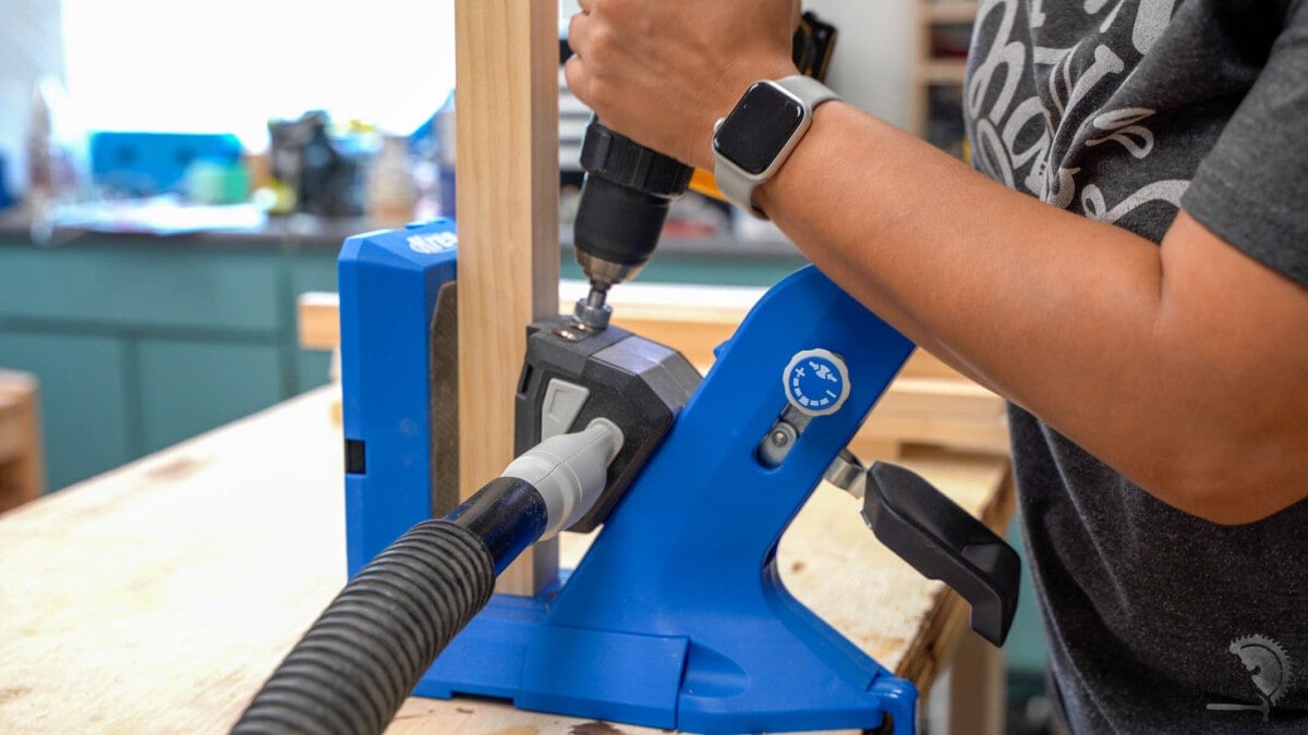 Woman making pocket hole in 2x2 using a Kreg 720.