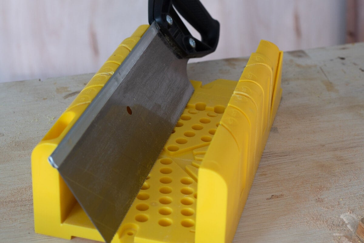 grooves in miter box and the lip on the saw.