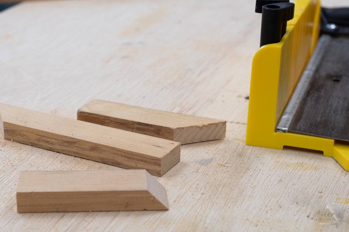 boards cut with miter box at different angles on workbench.