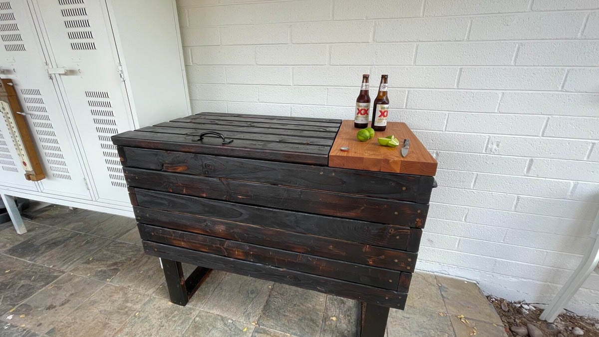 dark stained wood box on legs with lighter stained cutting board