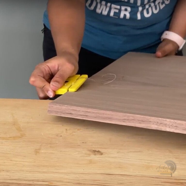 woman cutting edge banding with trimmer