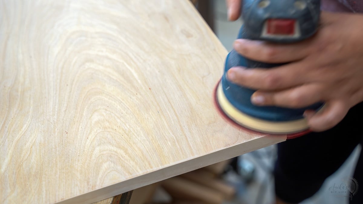 using a random orbital sander to remove excess edge banding