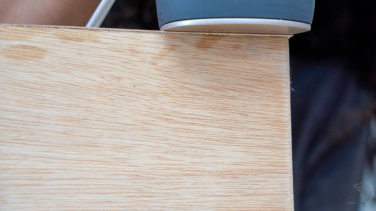 close up under the iron showing the glue oozing out of the edge banding