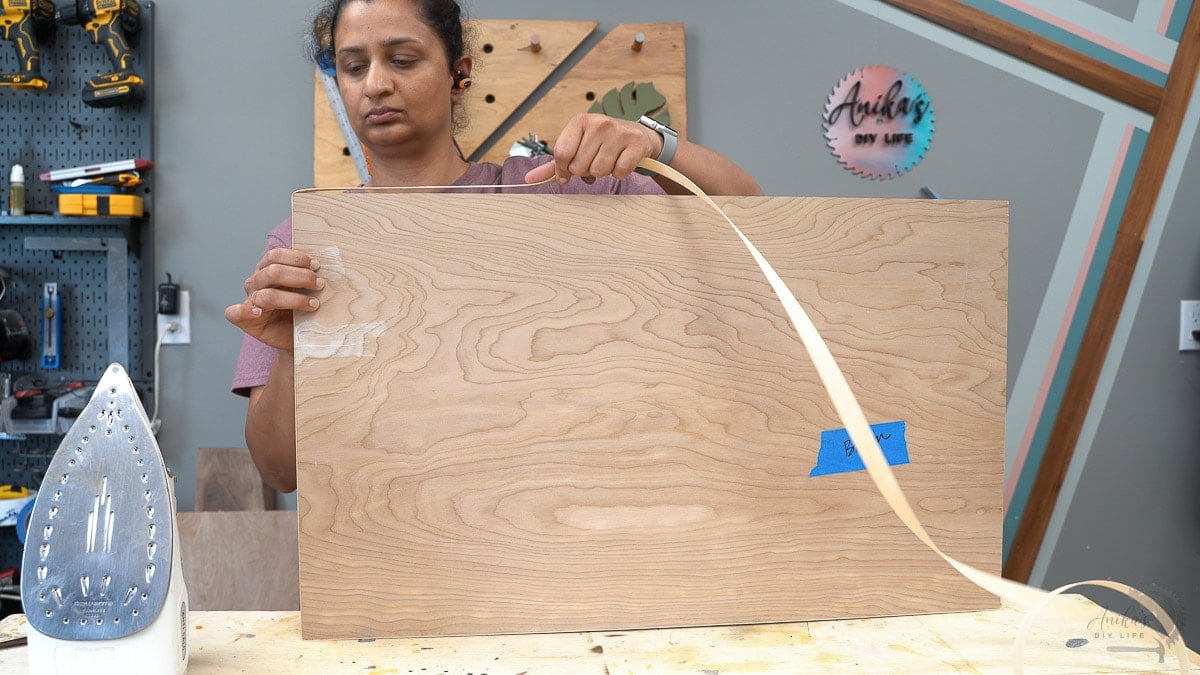 Woman turning edge banding on the corner of a piece of plywood