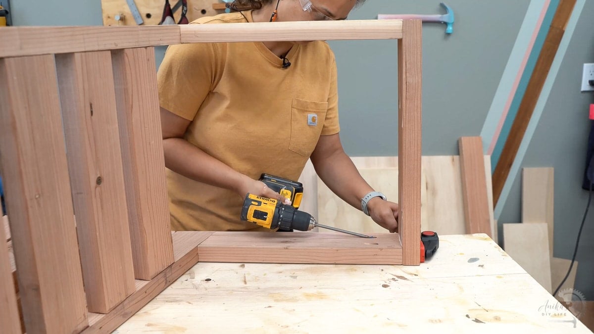 woman attaching the front apron using pocket hole screws