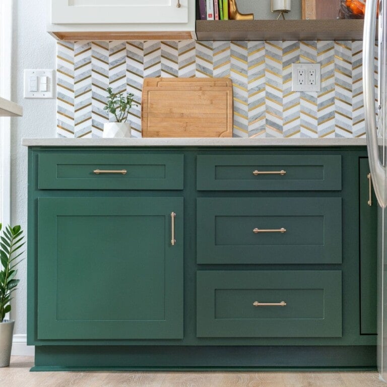 Green kitchen cabinnets with tile backsplash