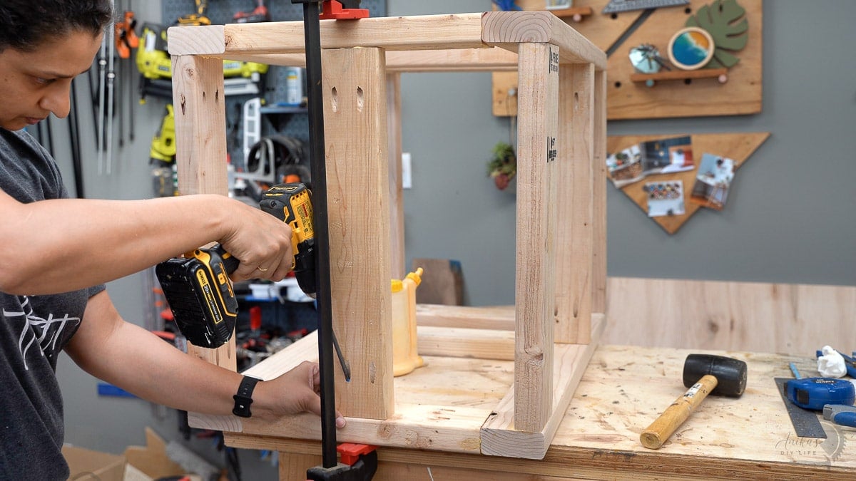 Woman attaching 2x4 support using pocket hole screws