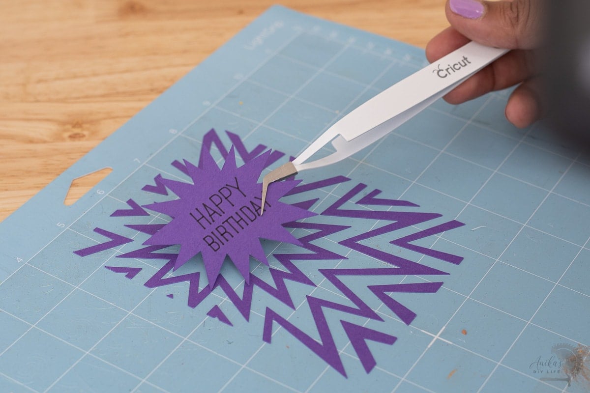 Using the reverse tweezer to pick up cut out