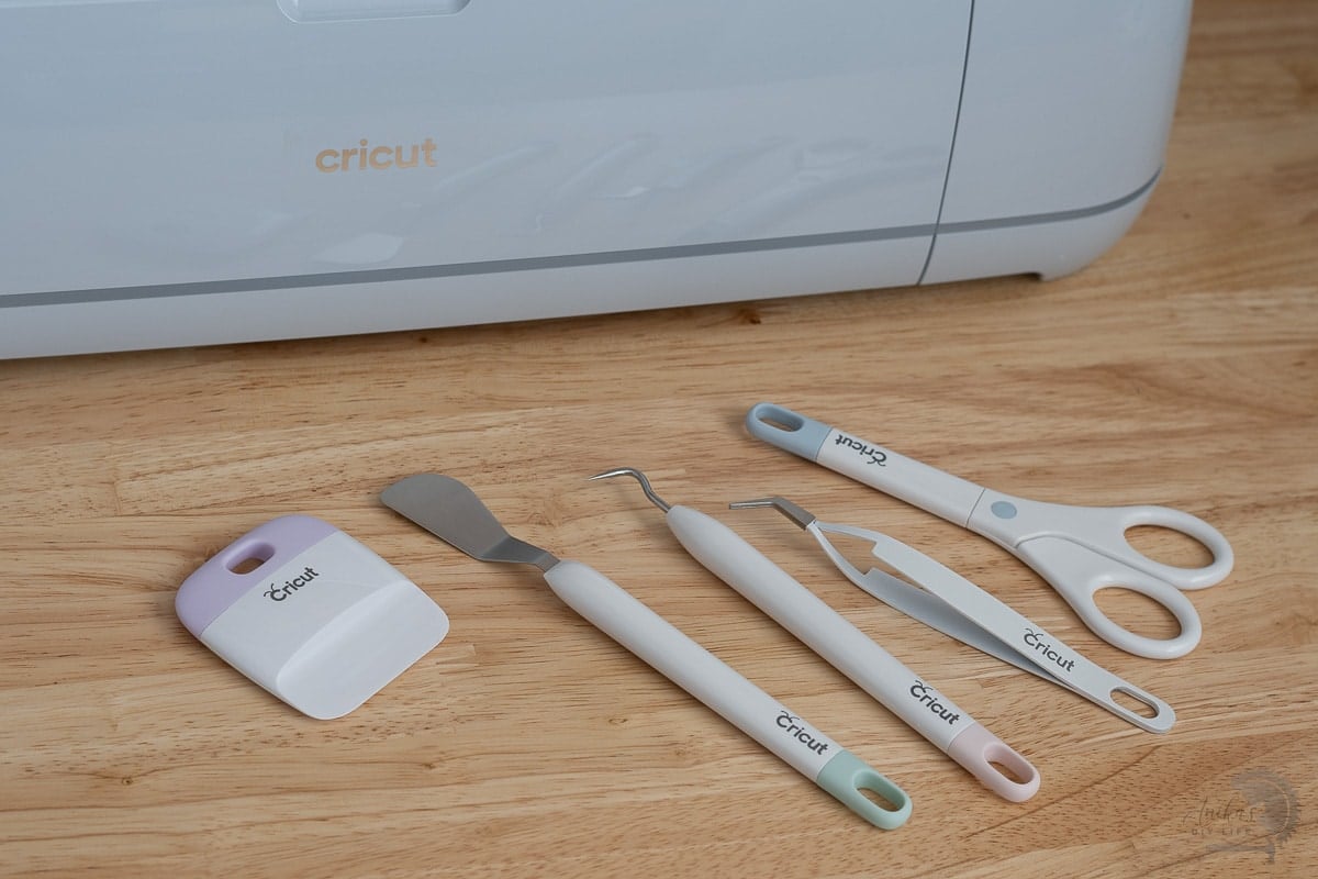 Cricut Machine with basic tools in front of it.