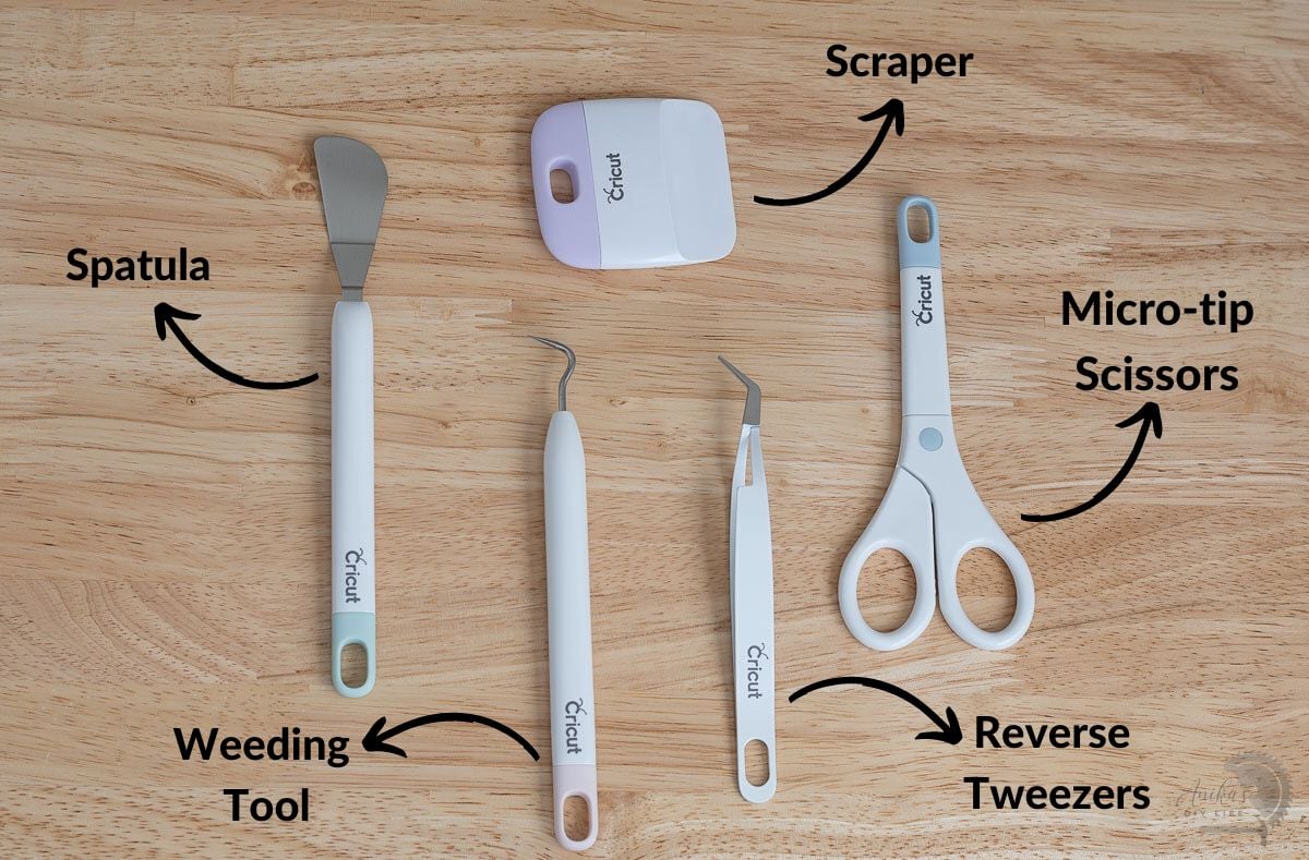 Basic cricut tools on desk labeled with names