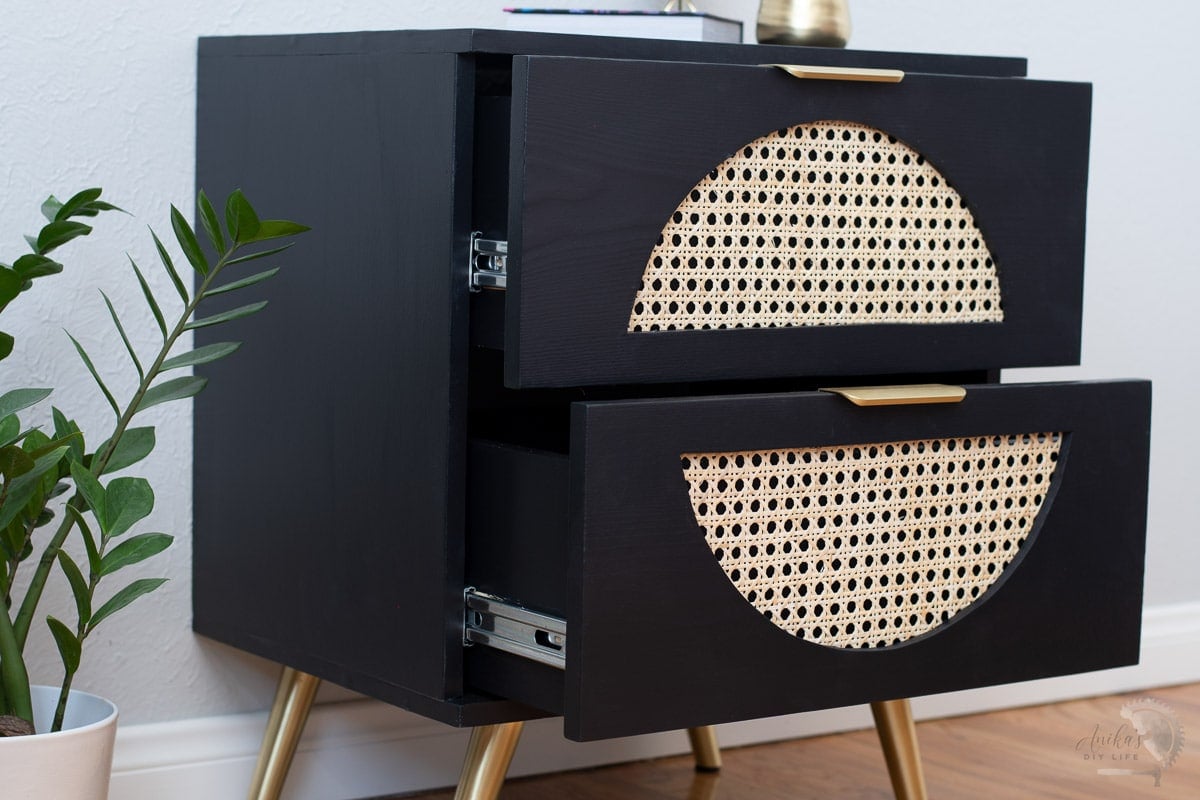 Cane nightstand with drawers open