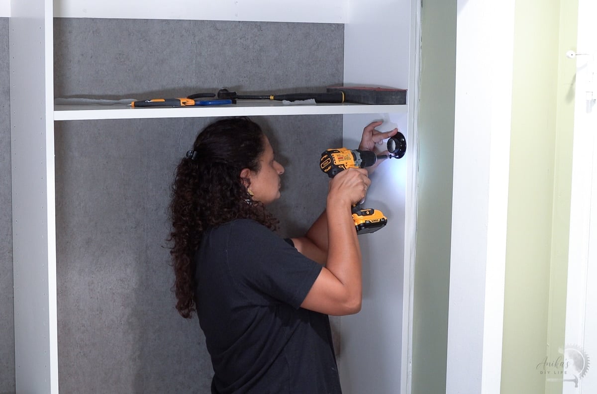 Woman attaching the closet rod bracket