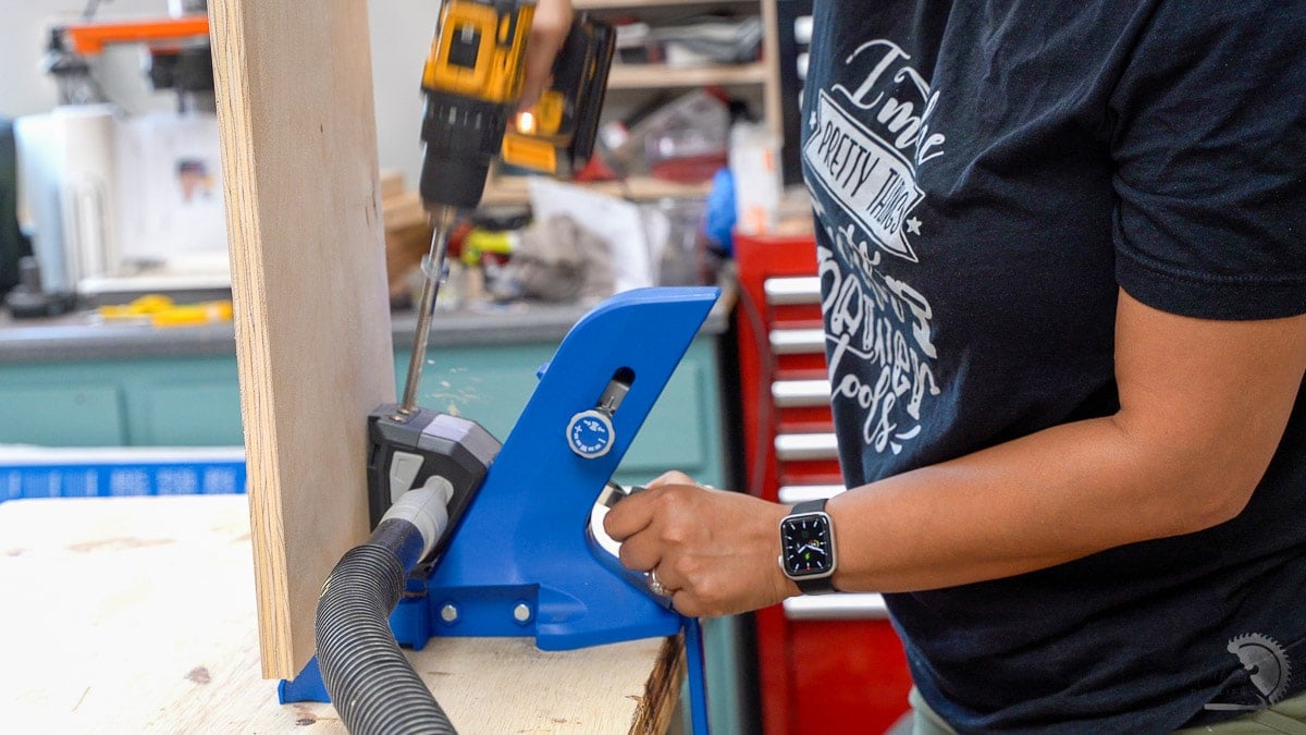 woman making pocket holes in plywood with Kreg 720