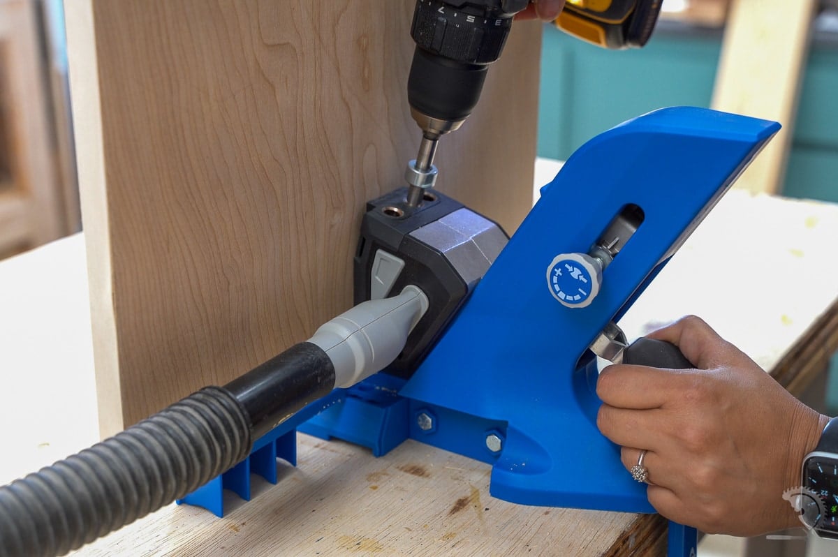 Woman making pocket holes in plywood
