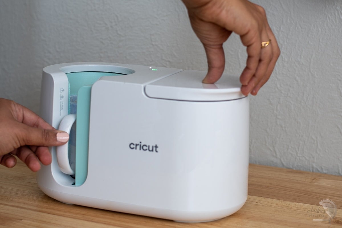 Placing mug is Cricut MugPress