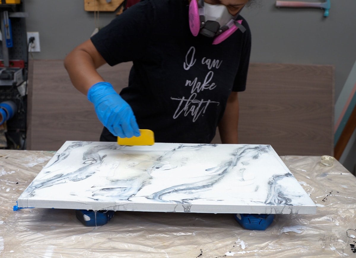 Woman making marble effect with epoxy